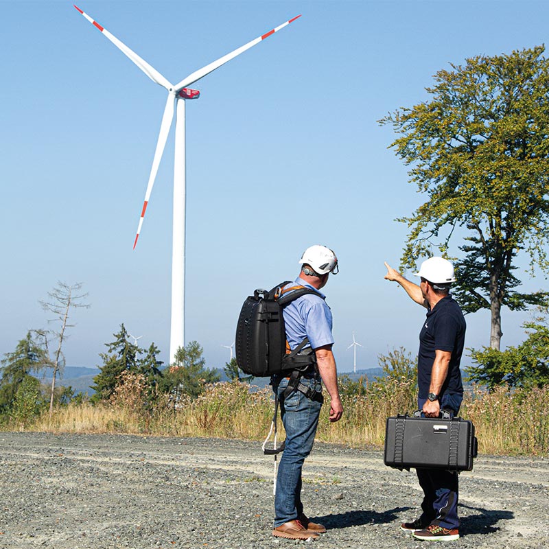 Two Inspectors with Borescope Looking at The Wind Turbine